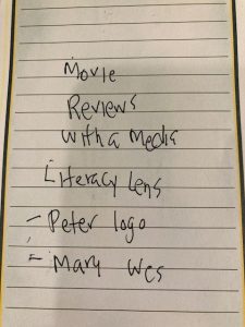 A piece of lined paper with scribbly writing that says "movie review with a media literacy lens Peter logo Mary Wes"